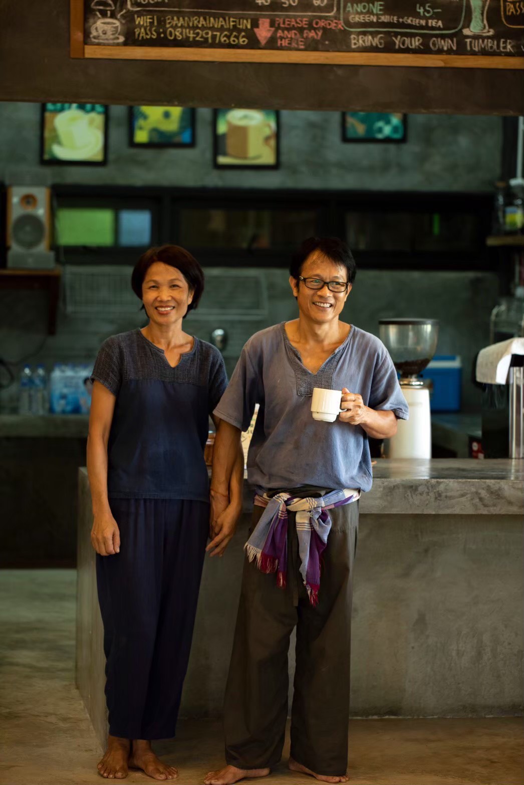Khun Noom and Khun Nuch, the founders of Baanrainaifun, standing in their garden